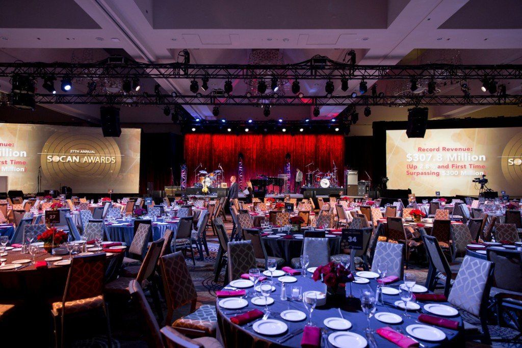 A large room with tables and chairs set up for a banquet.