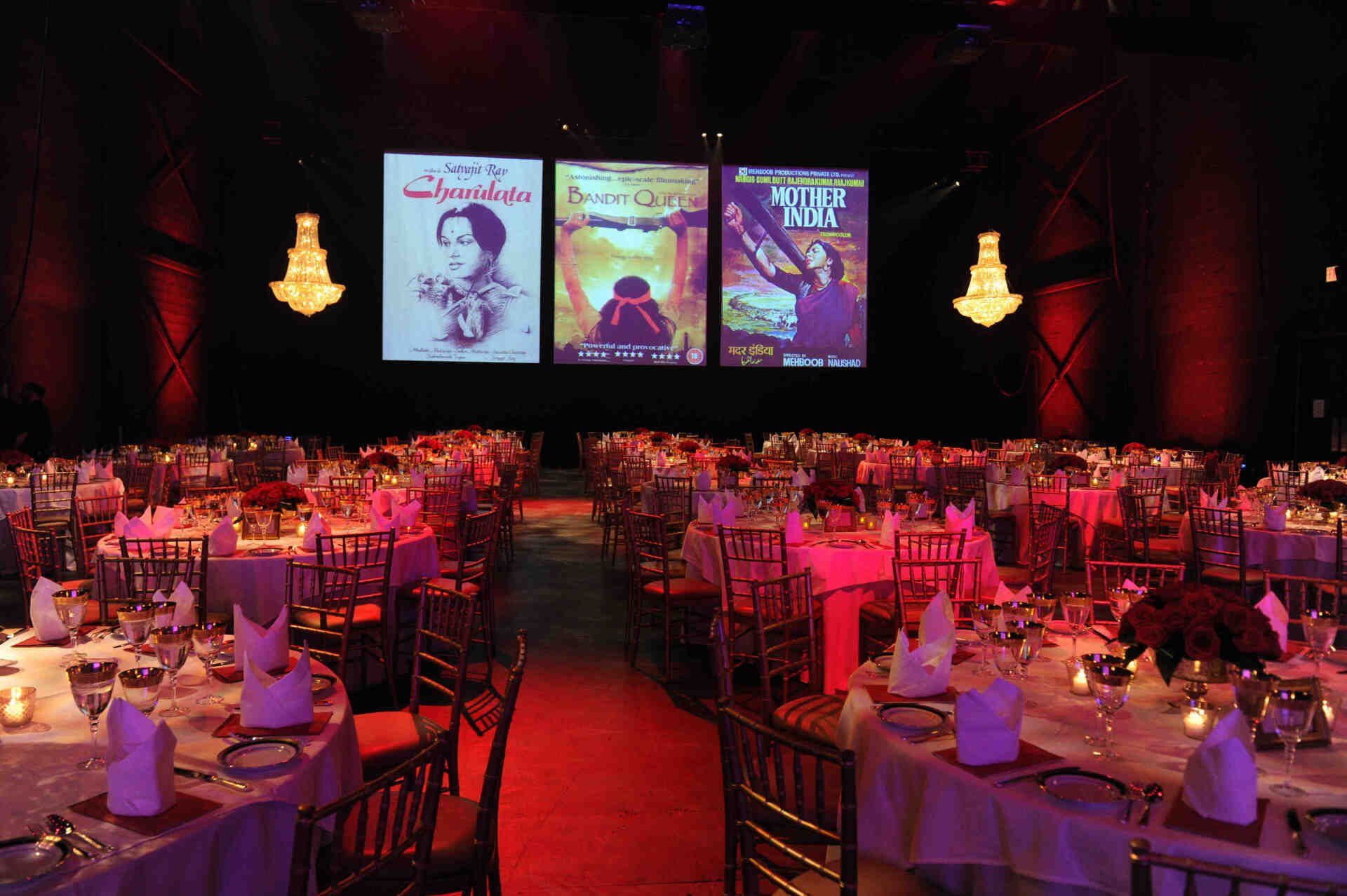 A large room with tables and chairs set up for a banquet
