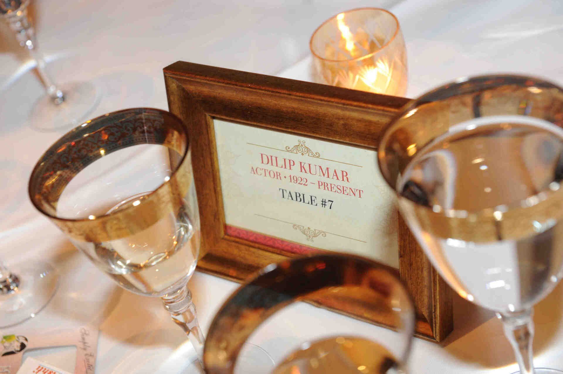 A table setting with wine glasses and a table number
