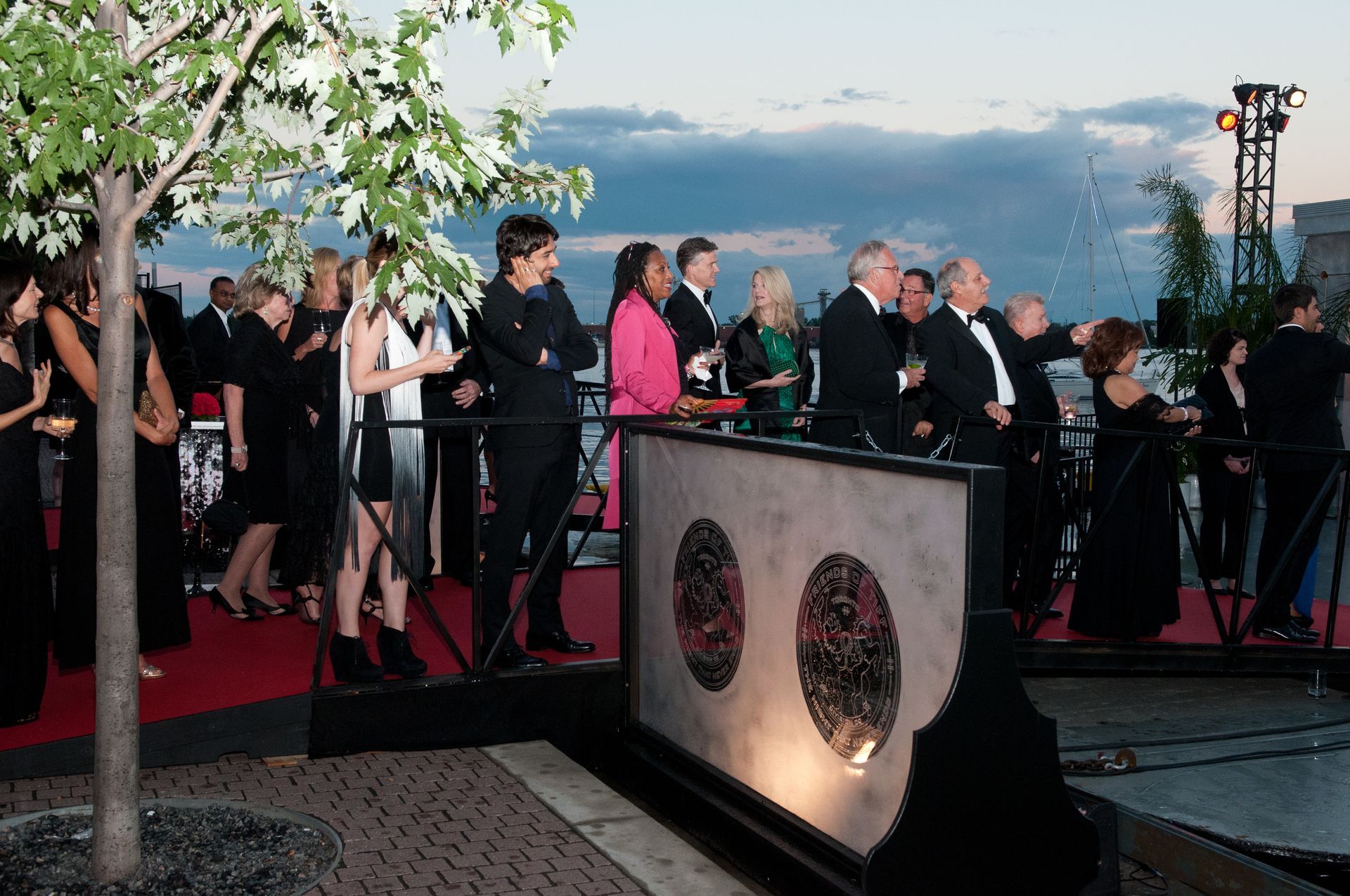 A group of people standing in front of a wall with circles on it
