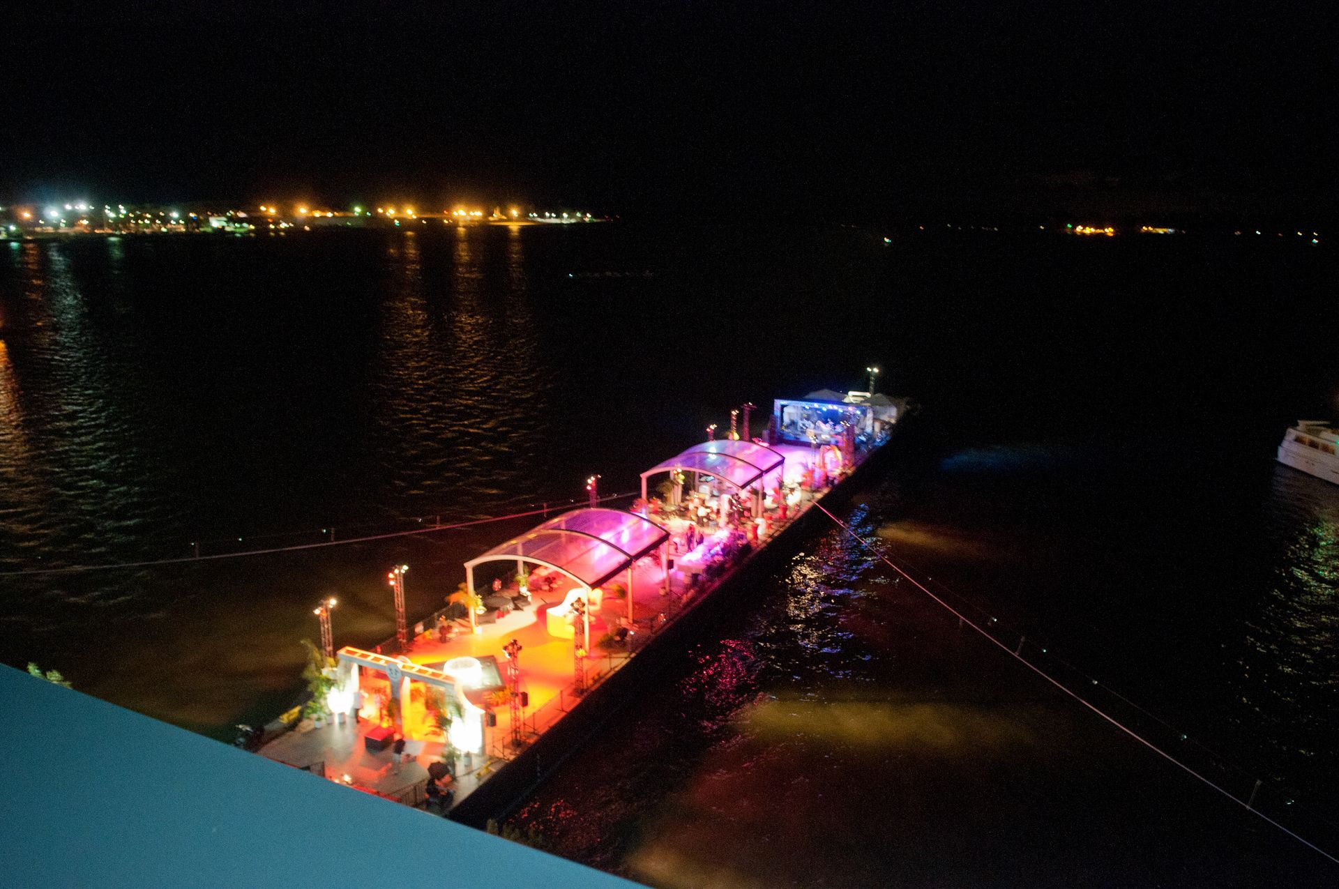 A large ship is docked in the water at night