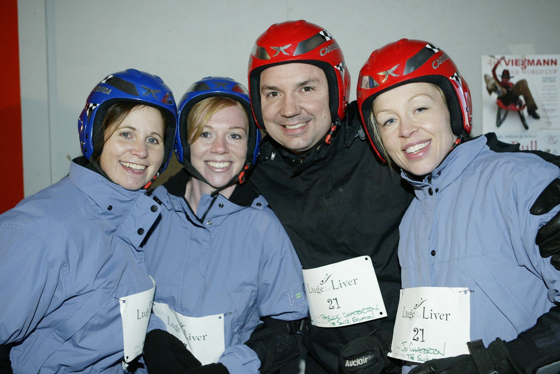 A group of people wearing helmets are posing for a picture