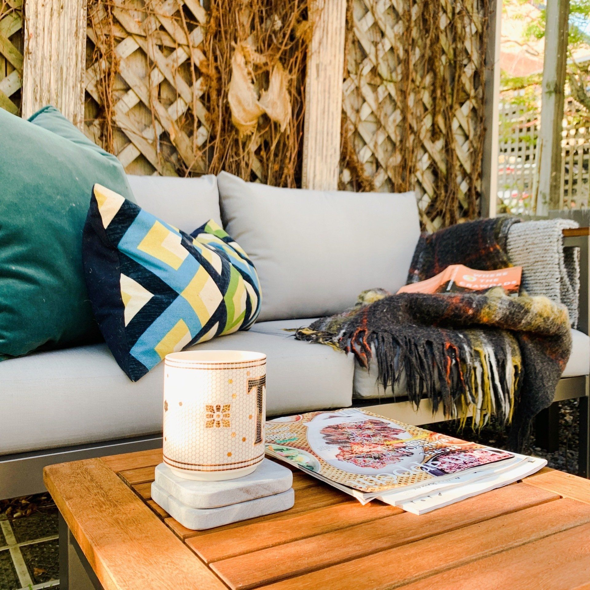 A couch with pillows and a magazine on a table