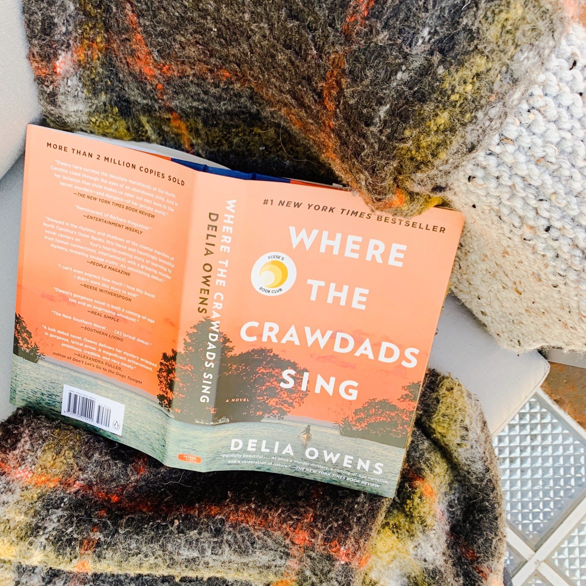 A book titled where the crawdads sing by delia owens