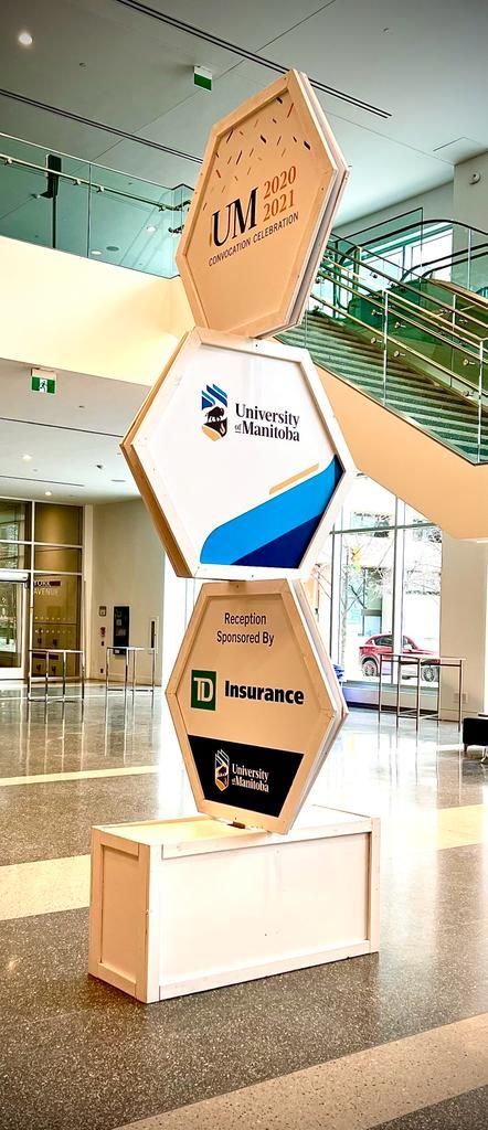 A large cardboard sculpture is stacked on top of each other in a lobby.