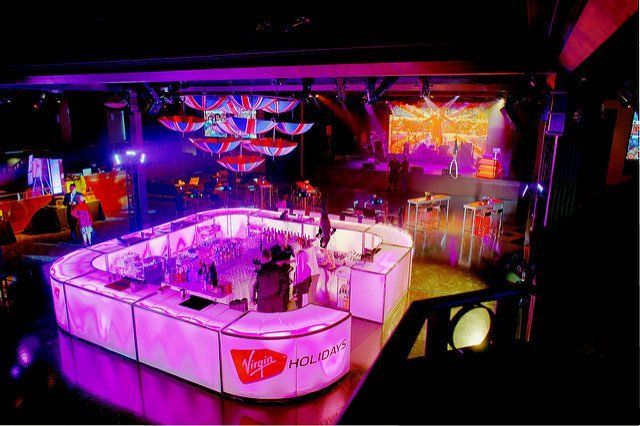 A bar in a nightclub with a virgin logo on it