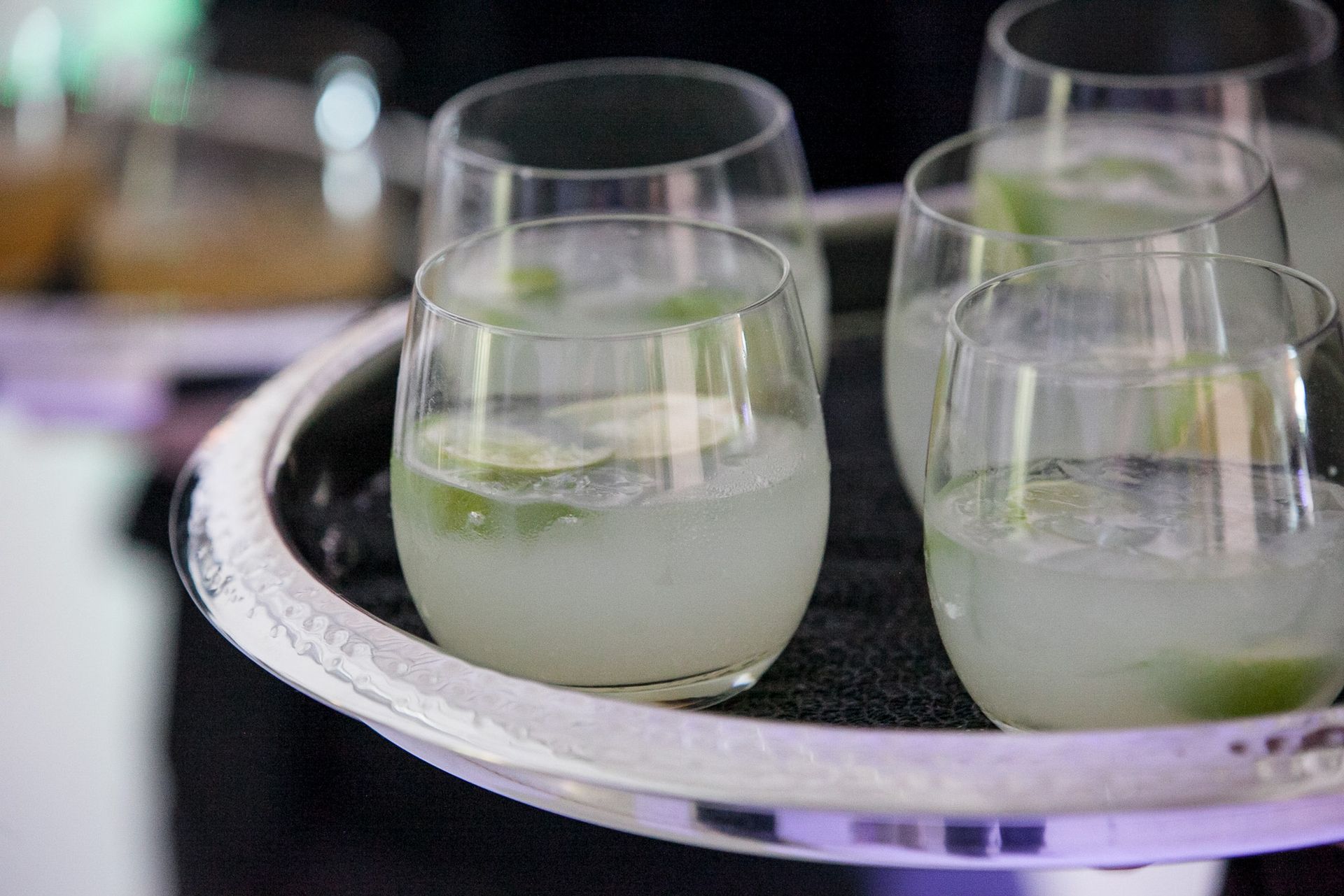 A tray filled with glasses of liquid on a table.