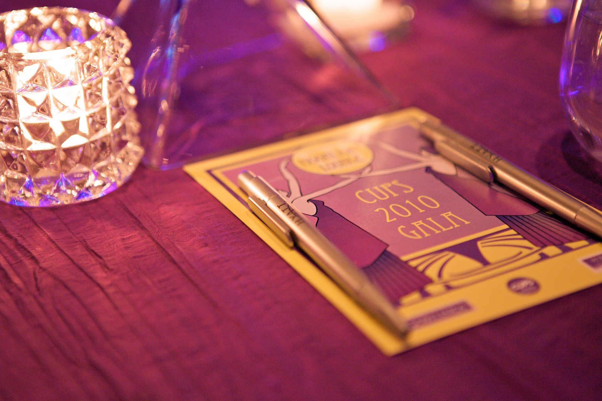 A purple table with a menu for the 2010 gala on it