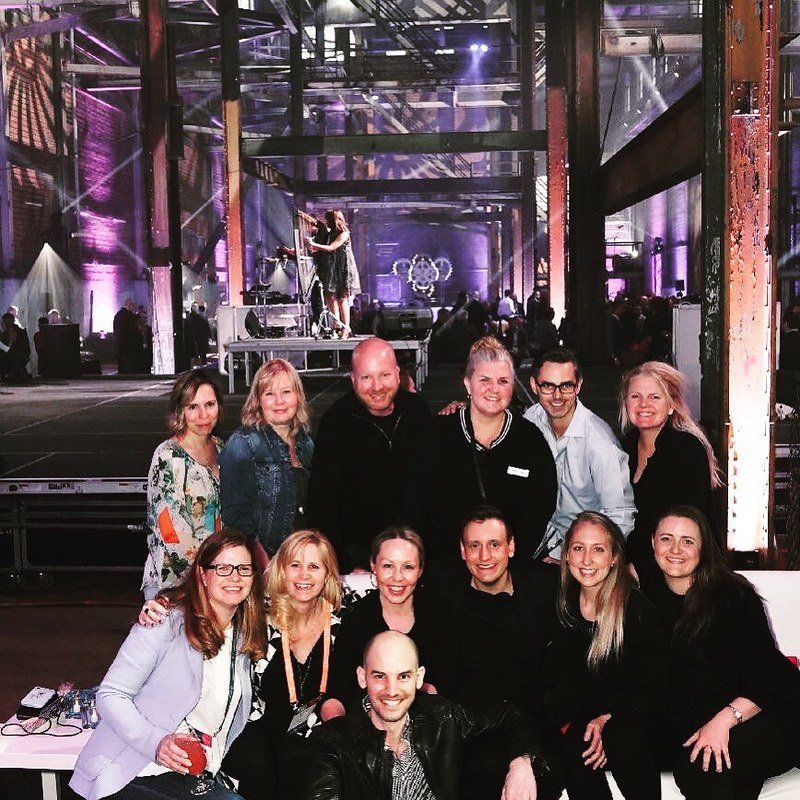 A group of people posing for a picture in a large room