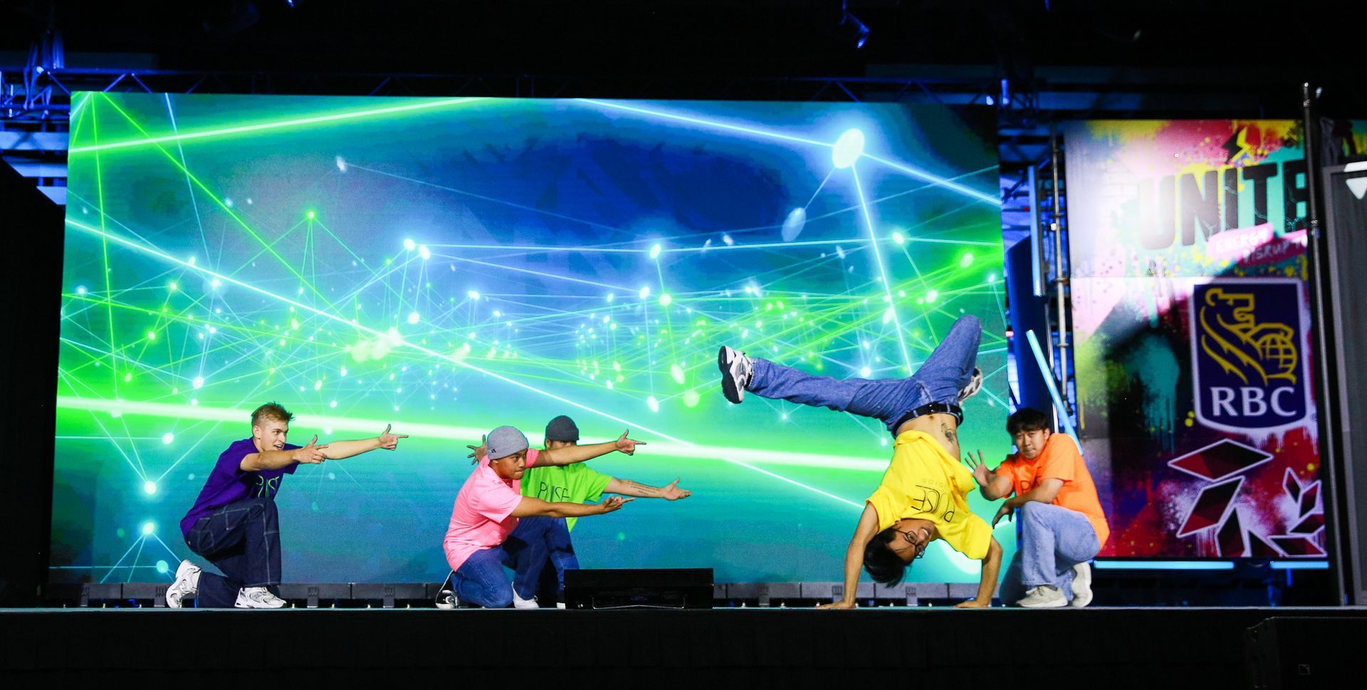 A group of people are doing a handstand on a stage.