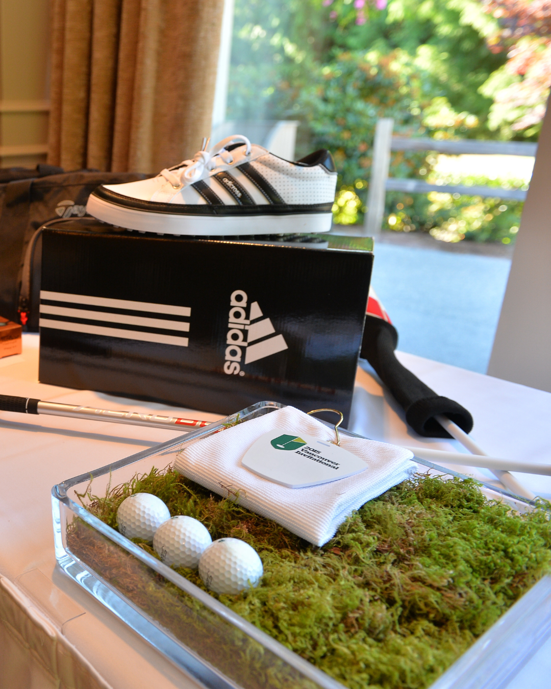 A pair of adidas shoes sitting on top of a box