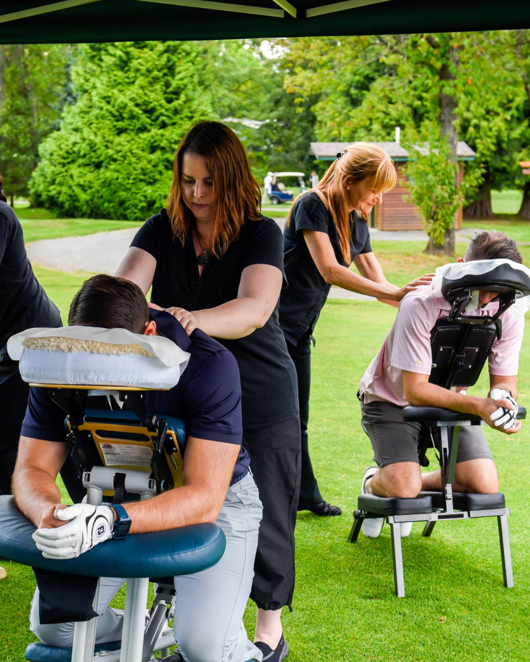 A group of people are getting a massage on a golf course.