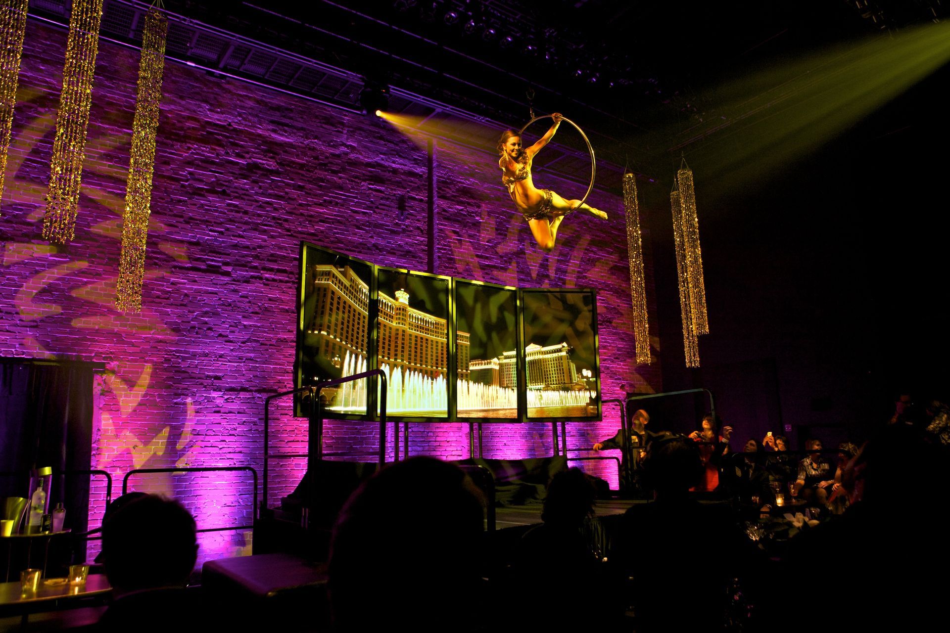 A woman is flying through the air in an aerial hoop