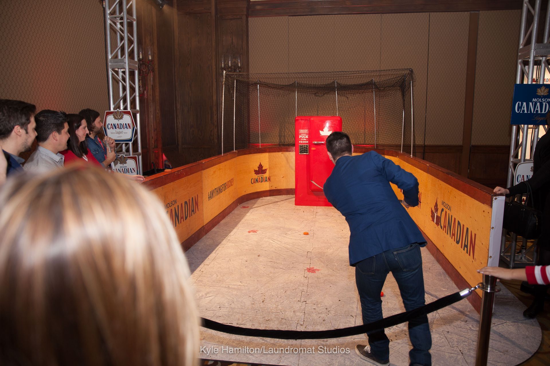 A man in a blue suit is playing a game of ice hockey