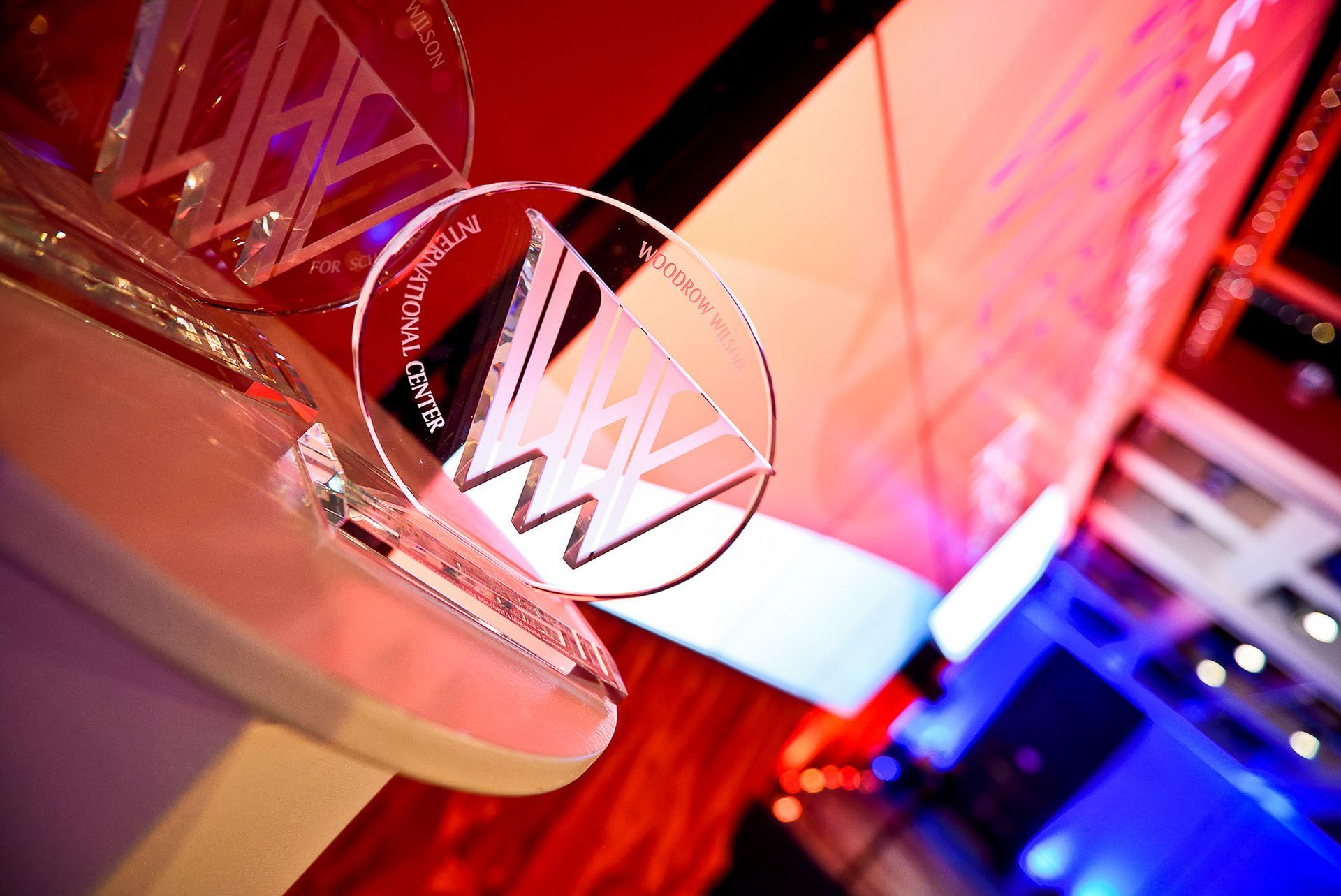 A trophy with the letter w on it is sitting on a table