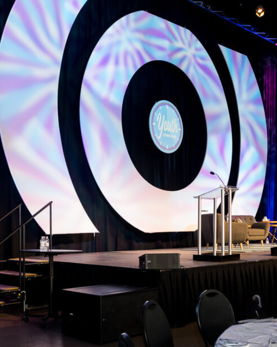 A stage with a large screen that says yeah