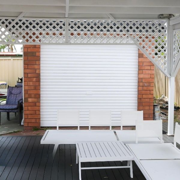 A Brick Wall With A White Shutter On It — APEX Painting & Maintenance In Primbee, NSW