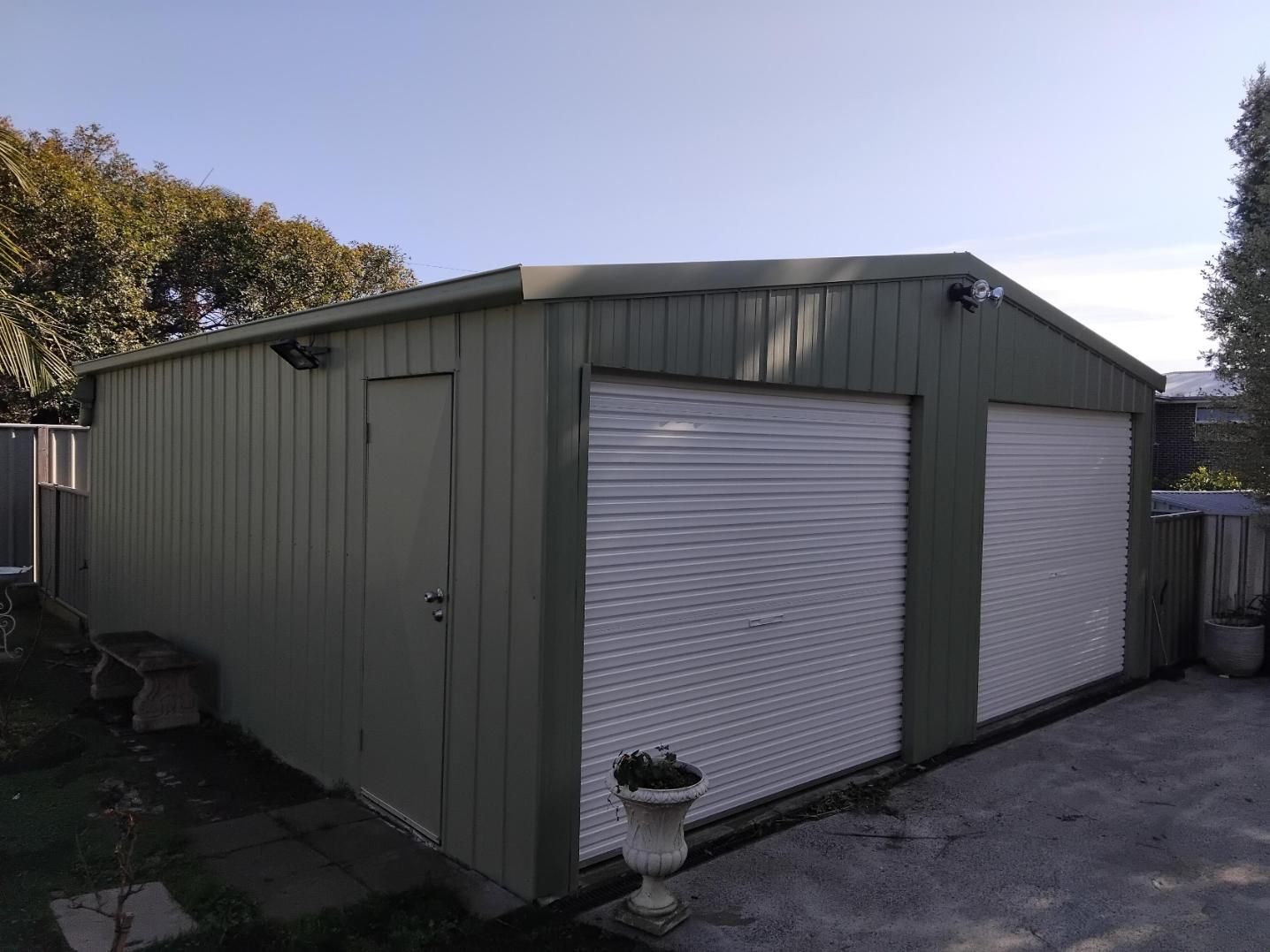 A Green Garage With A White Garage Door — APEX Painting & Maintenance In Primbee, NSW