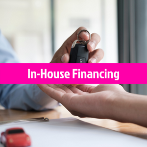 Car key held over pink banner reading “In-House Financing” with toy car on desk