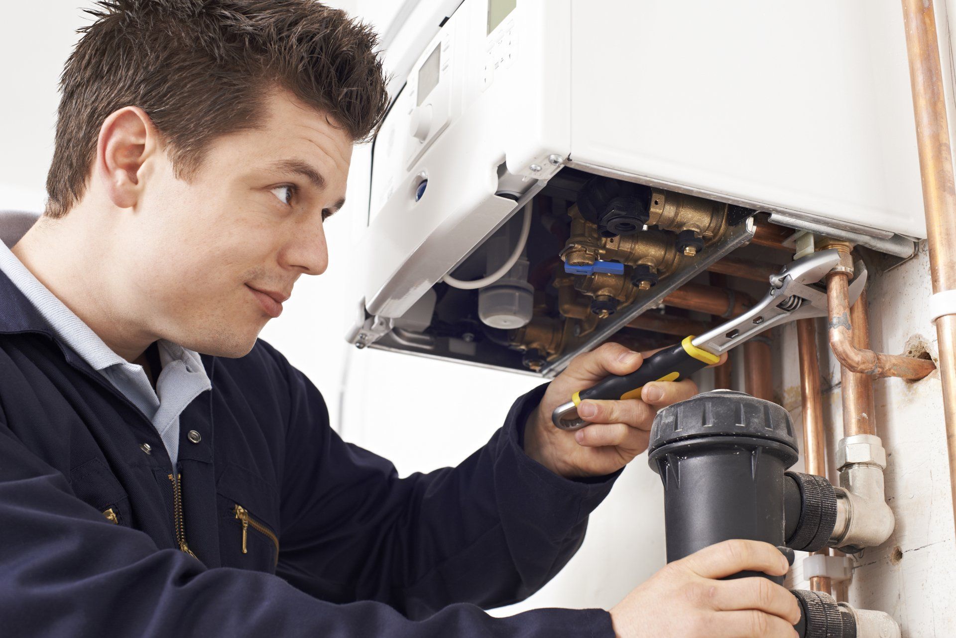 Heating System Repairs — Man Repairing A System In Sterling, CO
