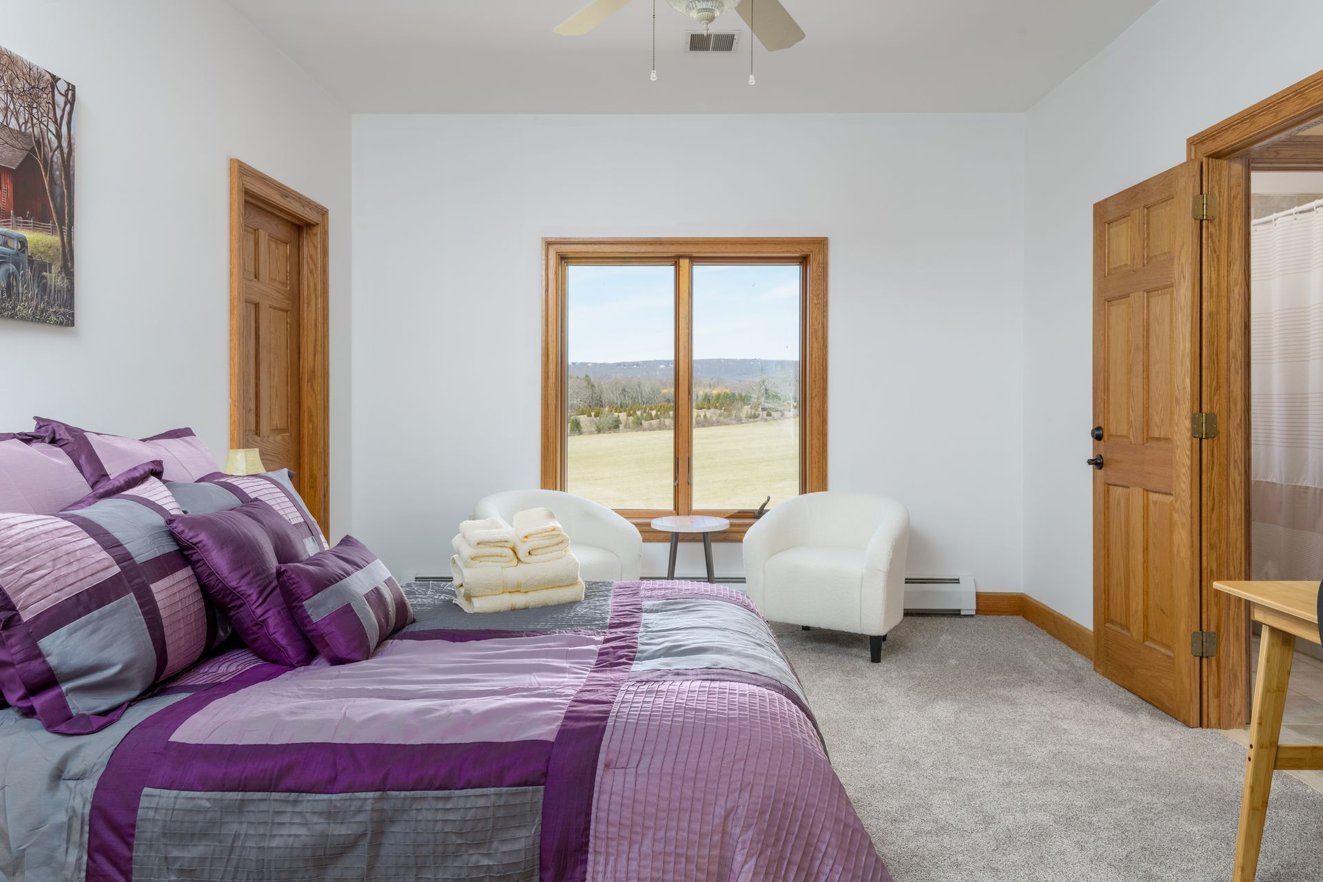A bedroom with a purple bed , chair , table and window at Chestnuthill Countryside Manor