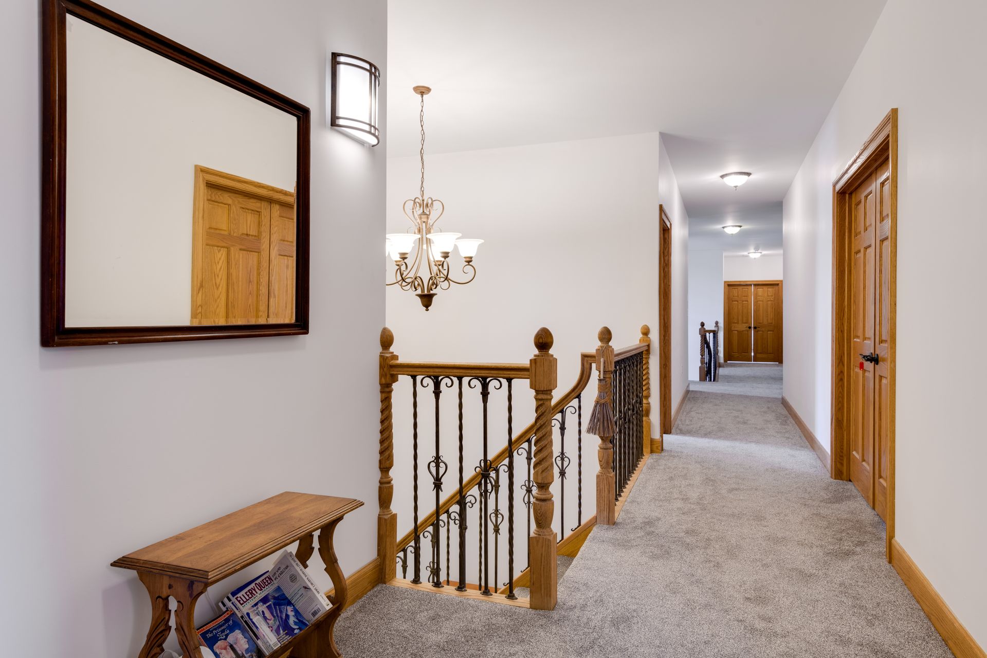 A hallway with a staircase and a mirror on the wall at Chestnuthill Countryside Manor