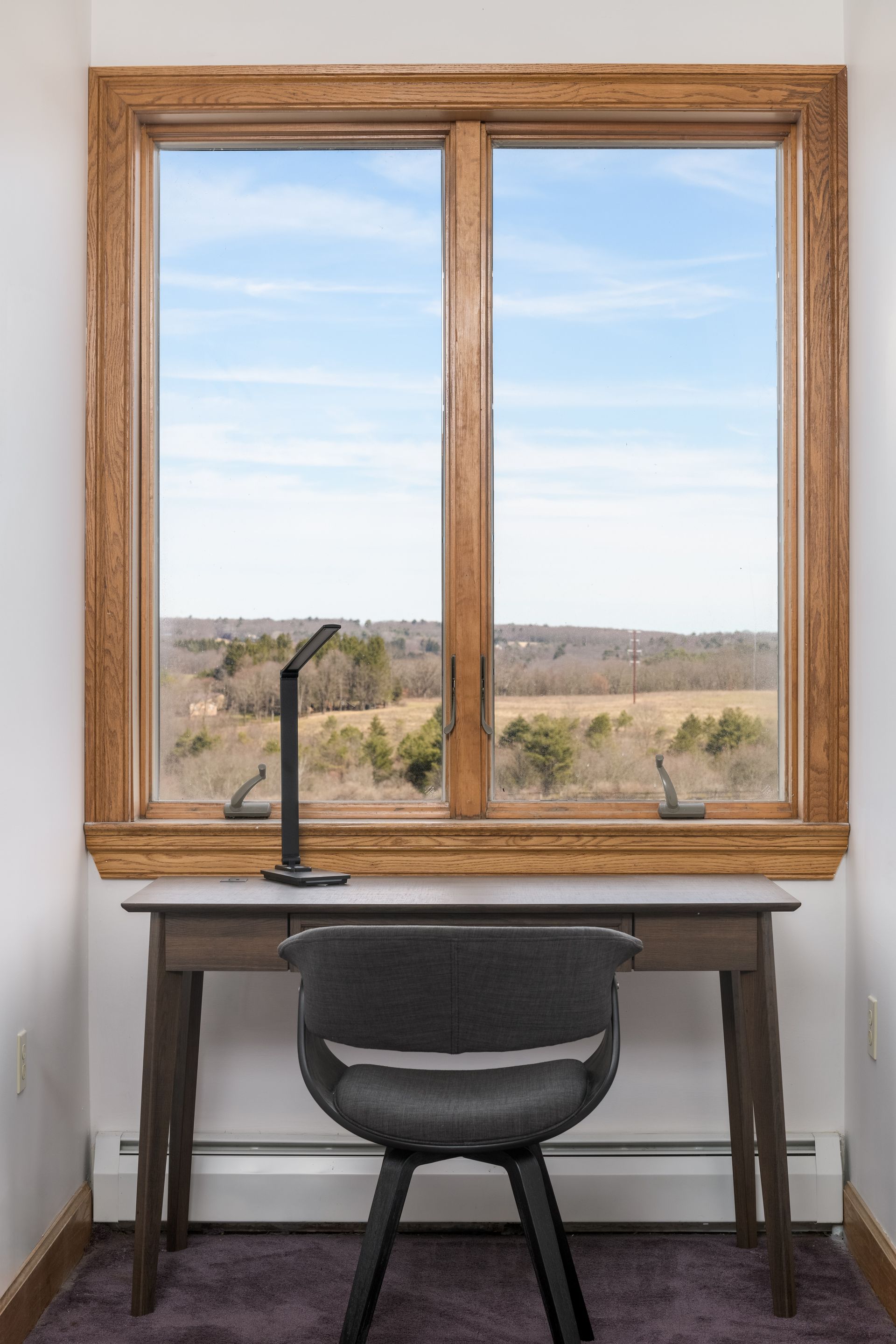 A desk with a chair and a lamp in front of a window at Chestnuthill Countryside Manor