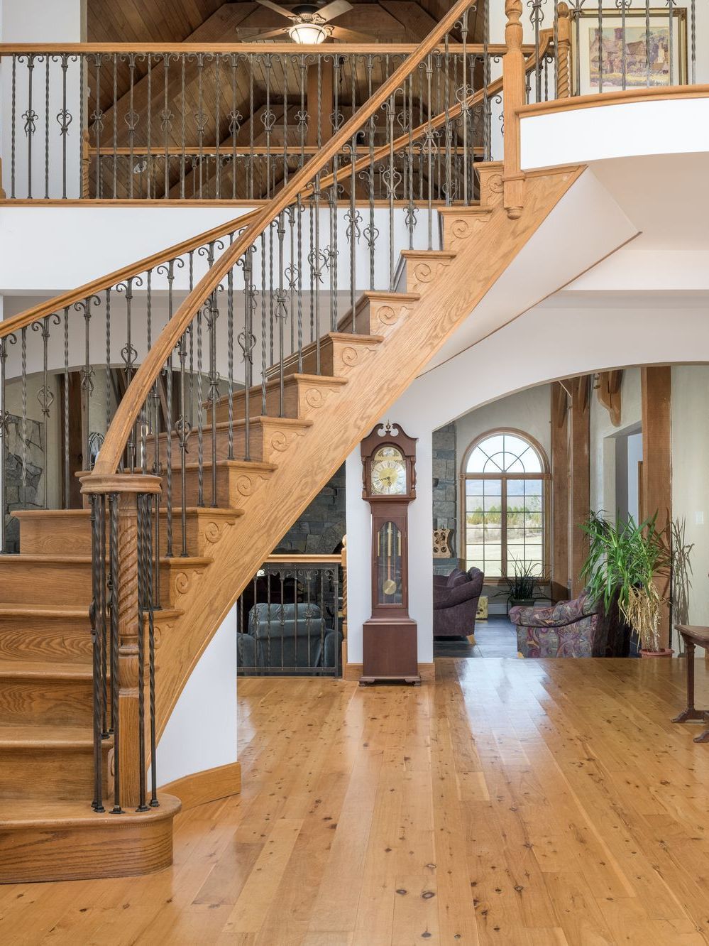 A wooden staircase in a house with a grandfather clock at Chestnuthill Countryside Manor