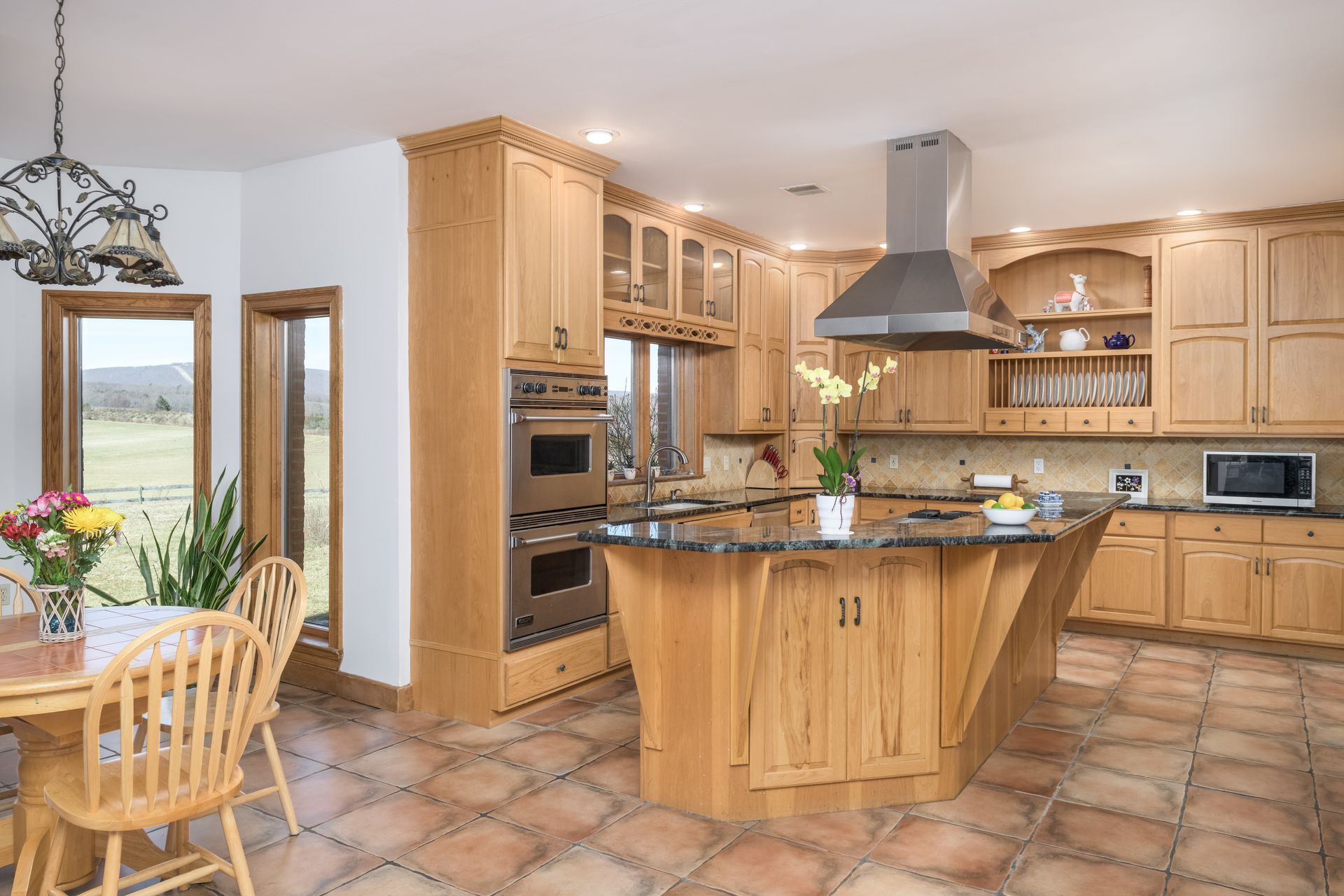 A kitchen with wooden cabinets and stainless steel appliances at Chestnuthill Countryside Manor