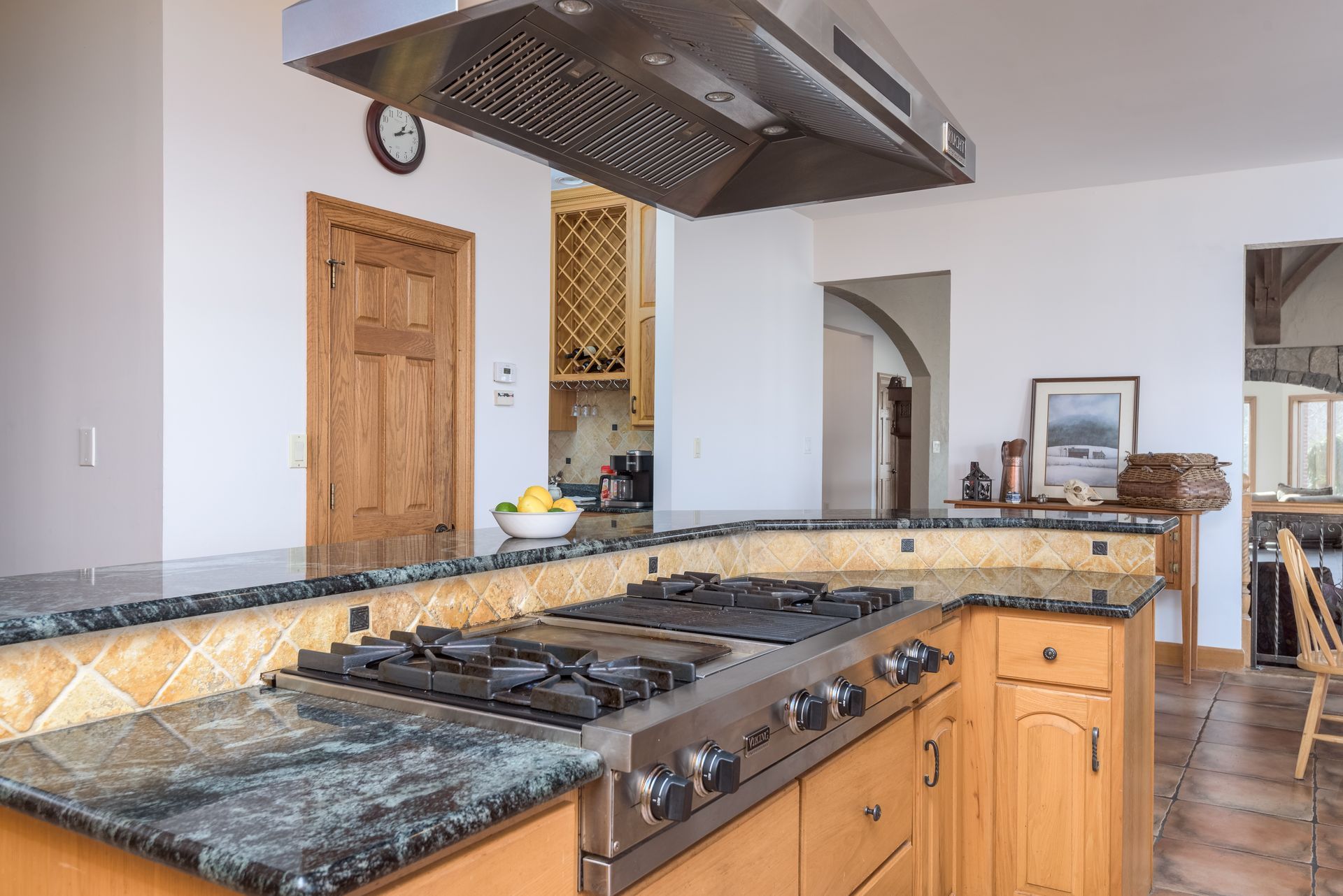A kitchen with a stove top oven and a clock on the wall at Chestnuthill Countryside Manor