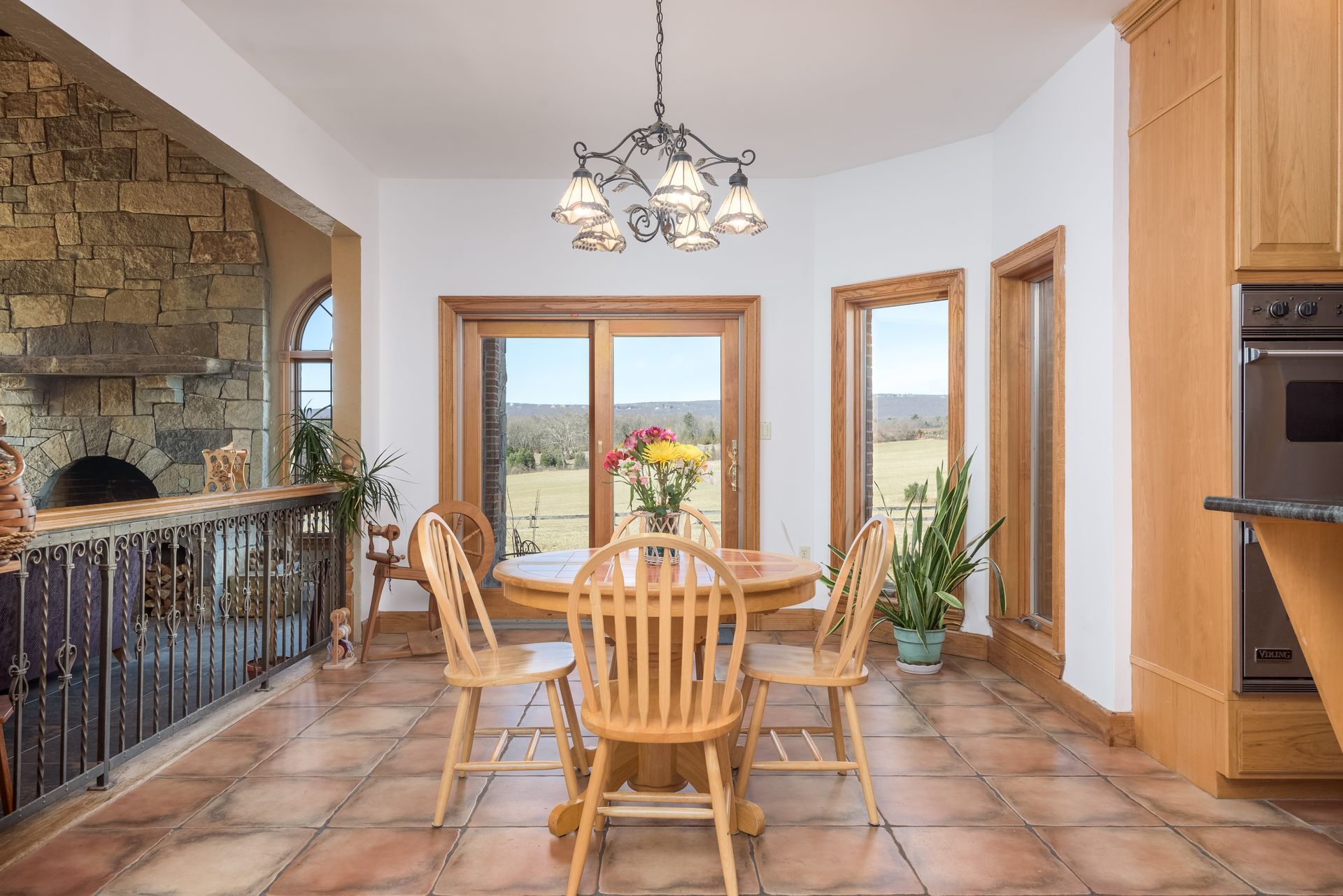 A dining room with a table and chairs and a chandelier at Chestnuthill Countryside Manor