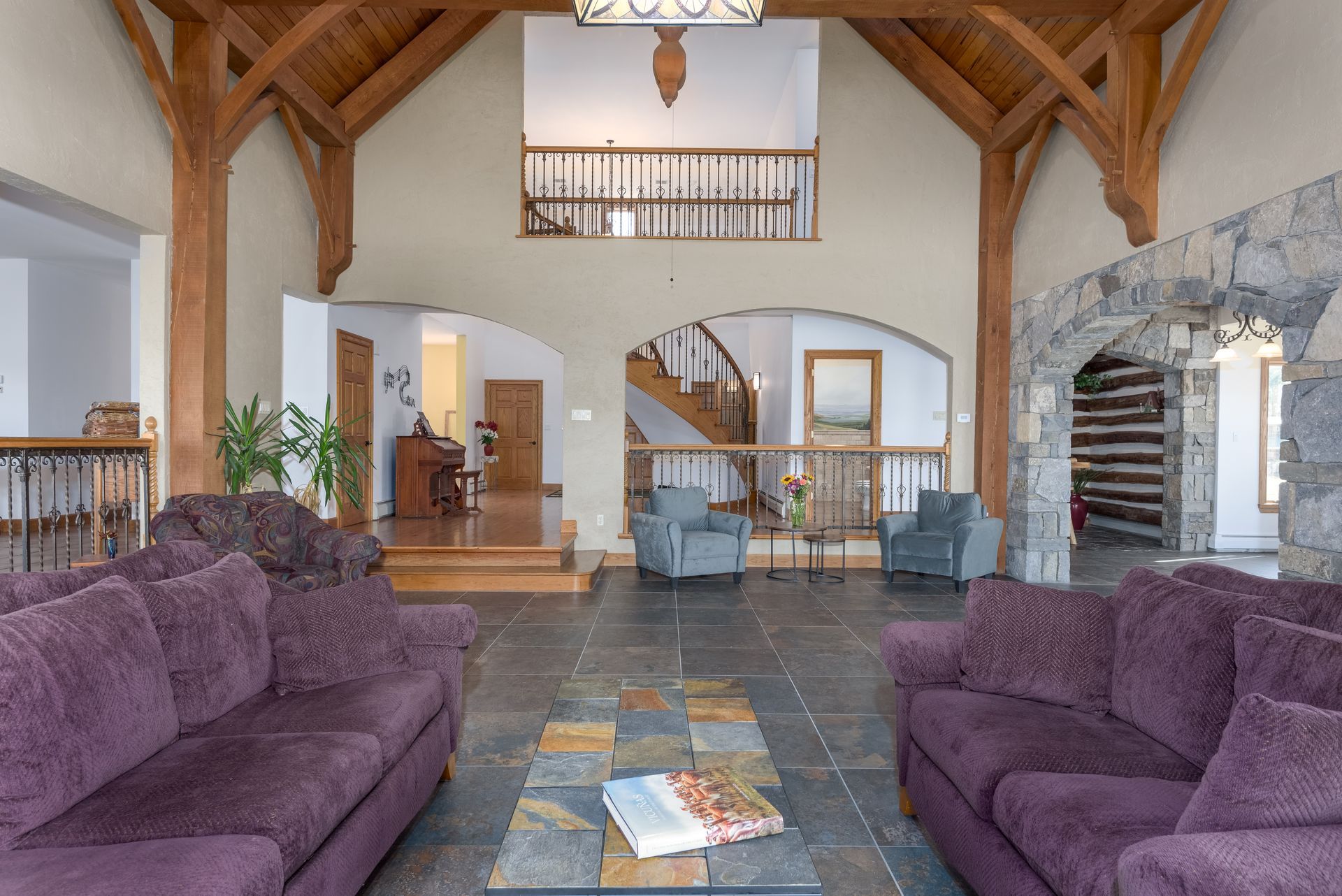 A living room with purple couches and a coffee table at Chestnuthill Countryside Manor