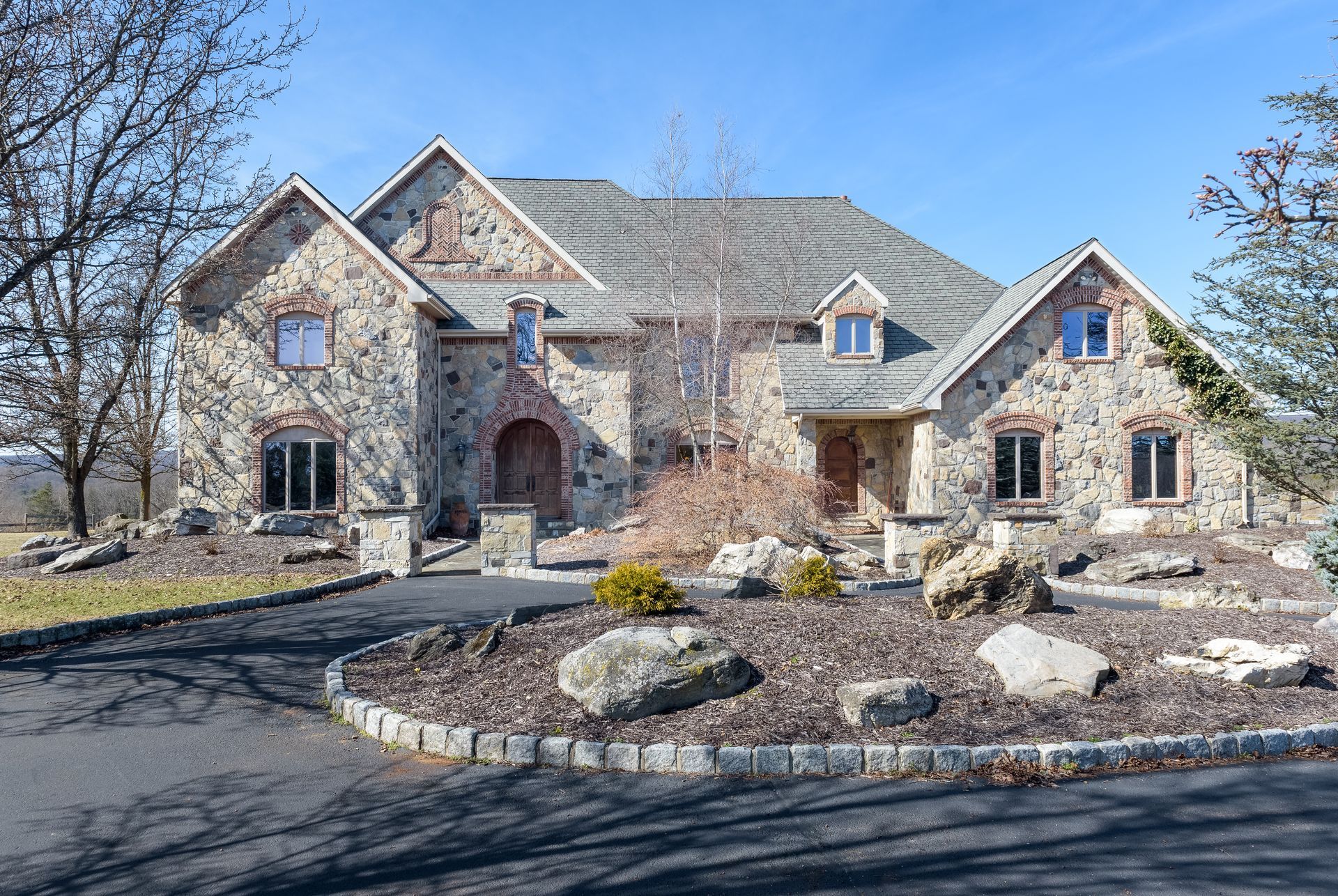 A large stone house with a gray roof is for sale at Chestnuthill Countryside Manor
