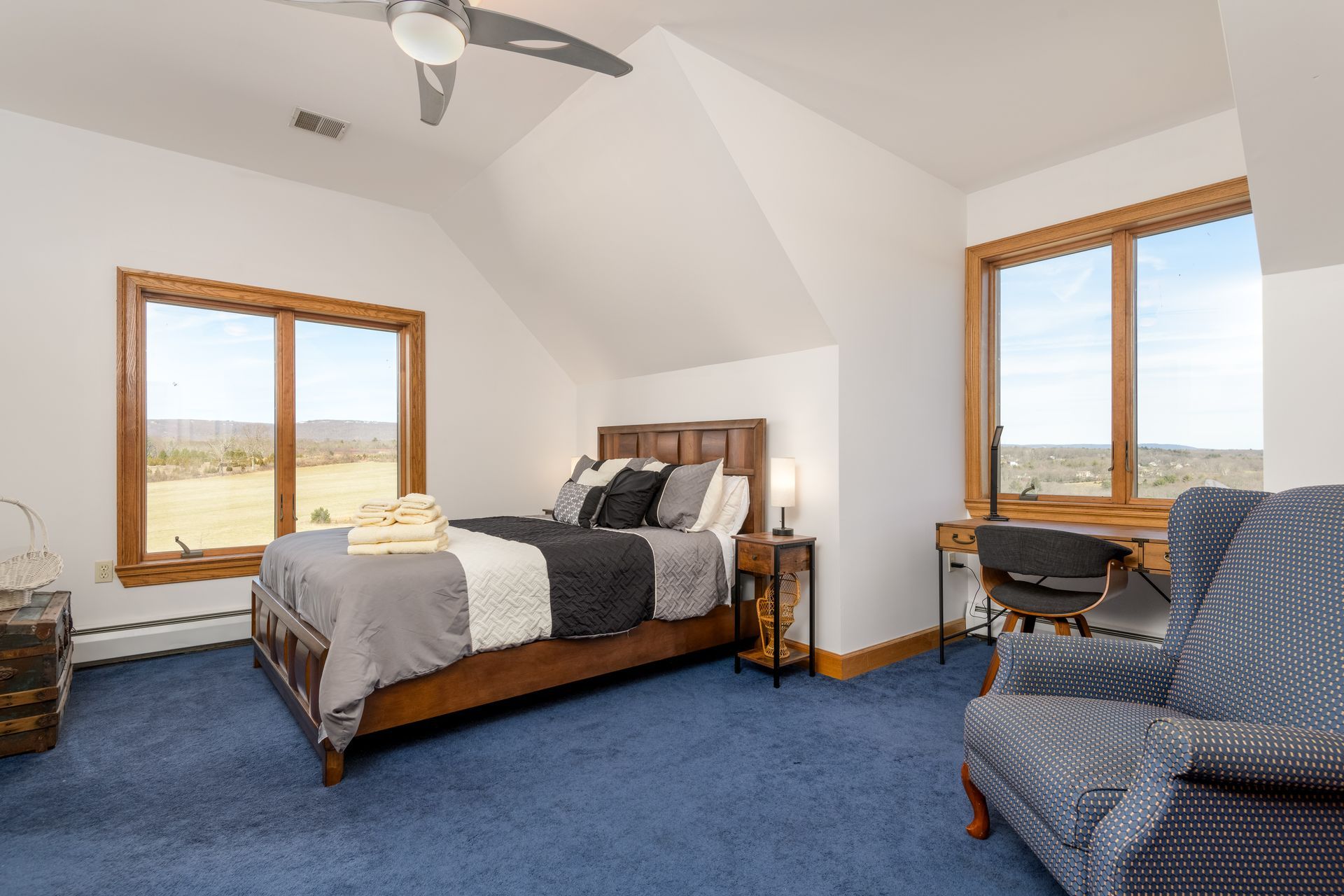 A bedroom with a bed , chair , desk and ceiling fanat Chestnuthill Countryside Manor