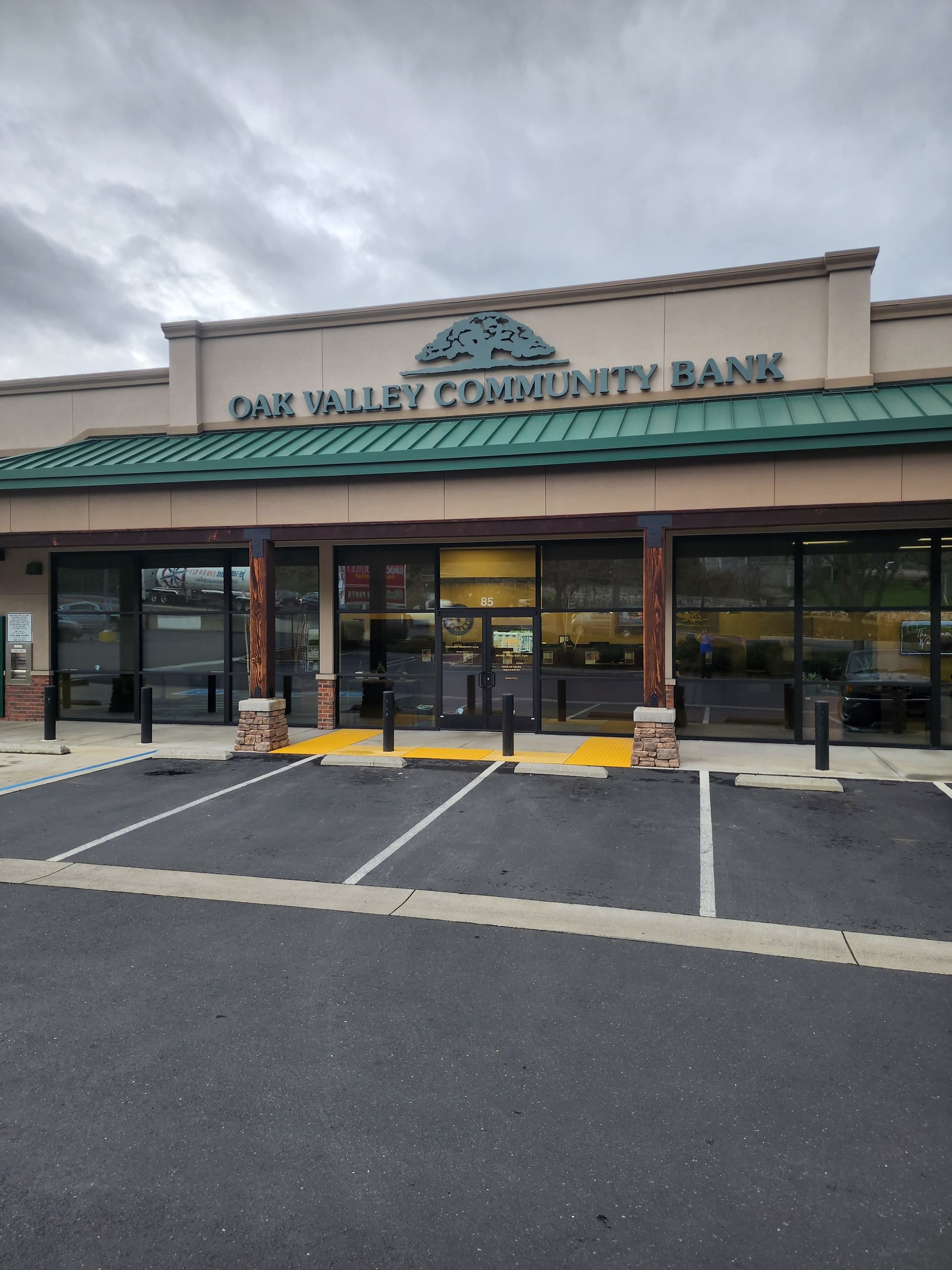 The oak valley community bank has a parking lot in front of it