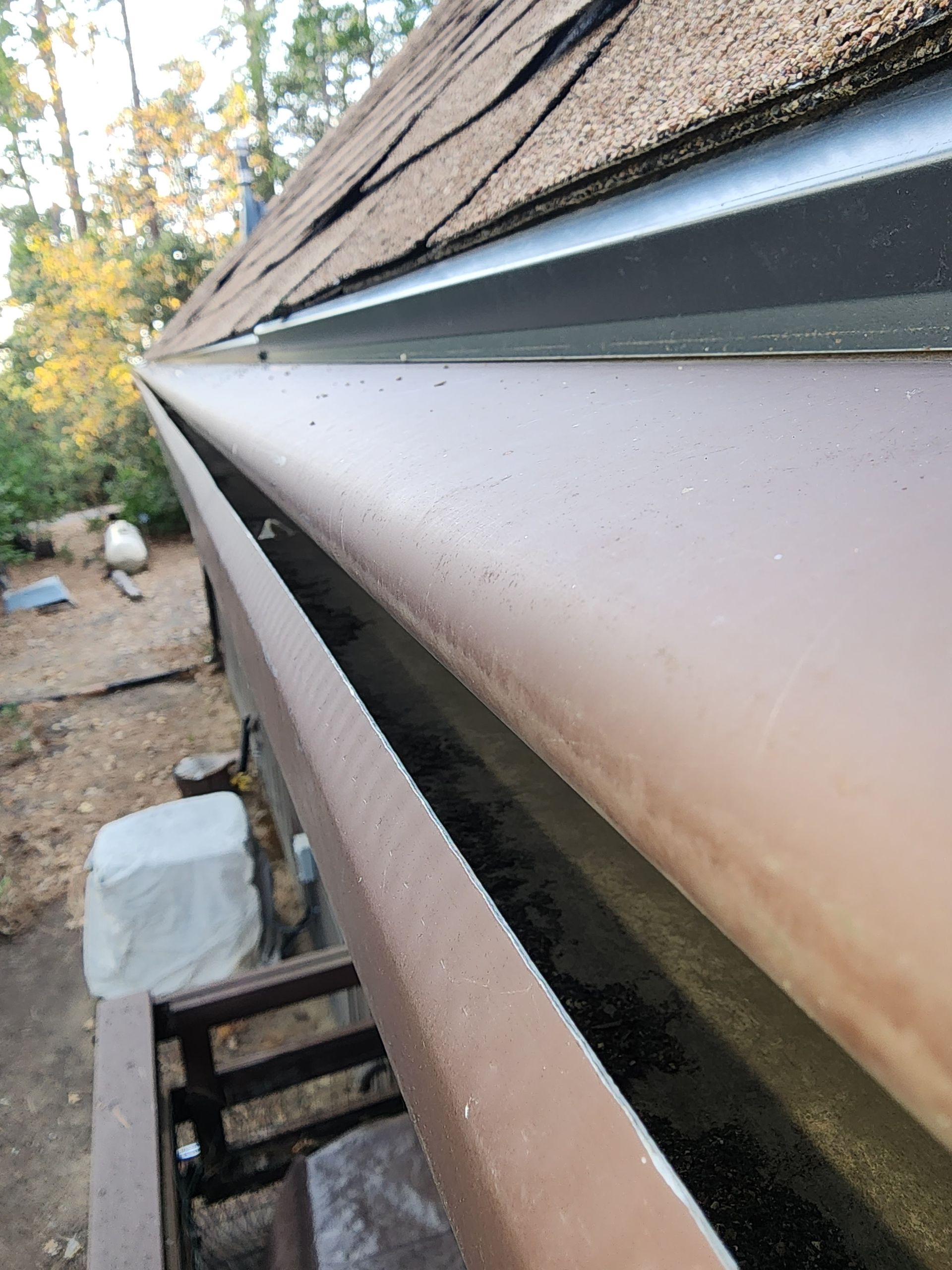 A close up of a brown gutter on a roof