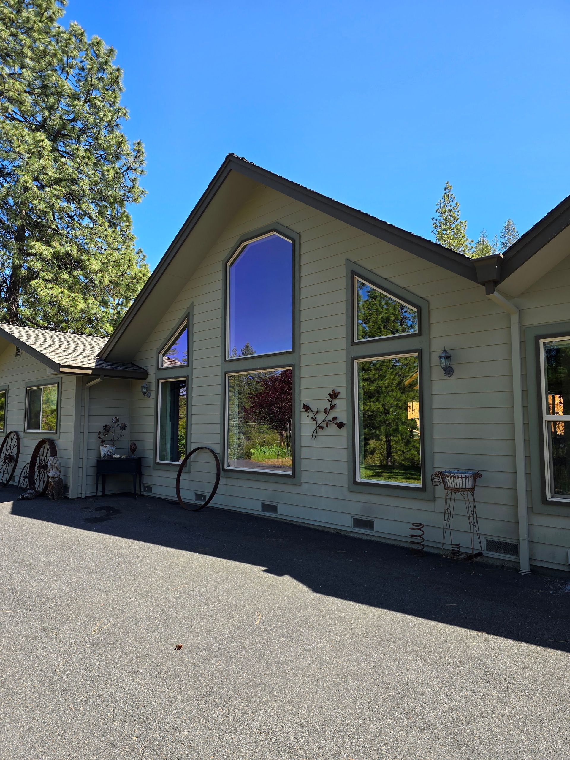 A house with a lot of windows and trees in the background
