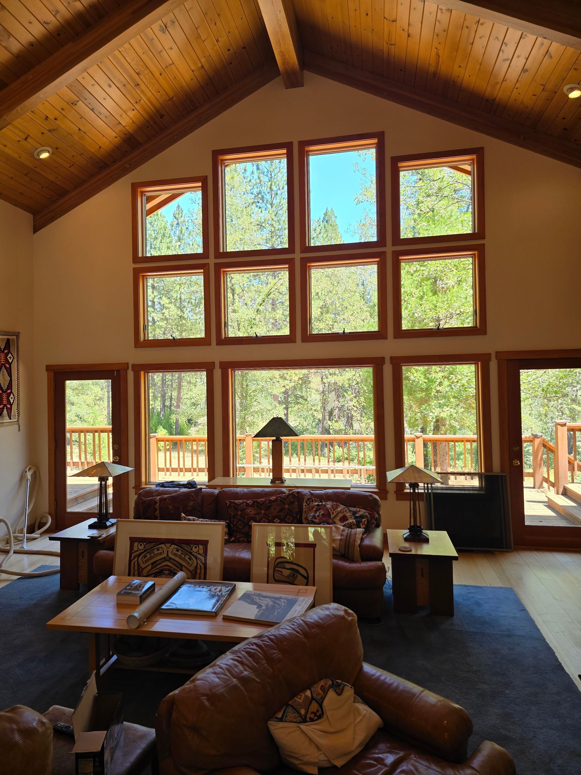 A living room with a vaulted ceiling and lots of windows