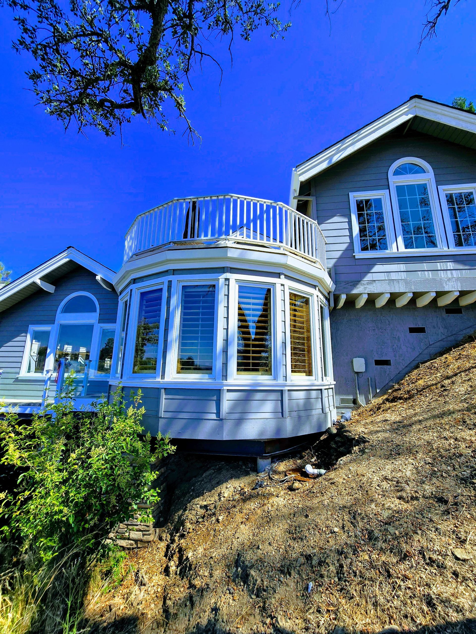 A large house is sitting on top of a hill.