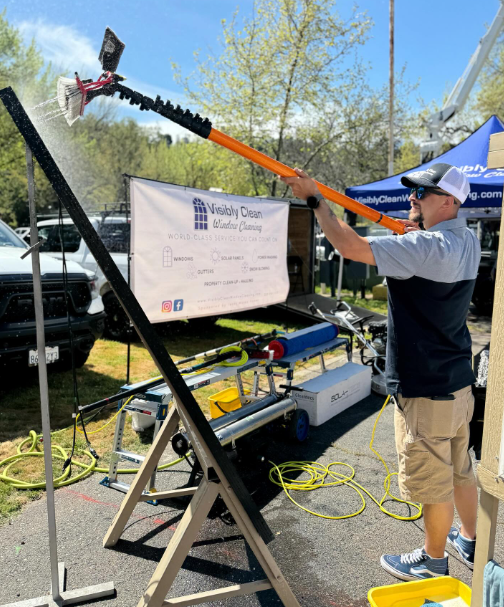 A man is standing in front of a sign that says valley coast