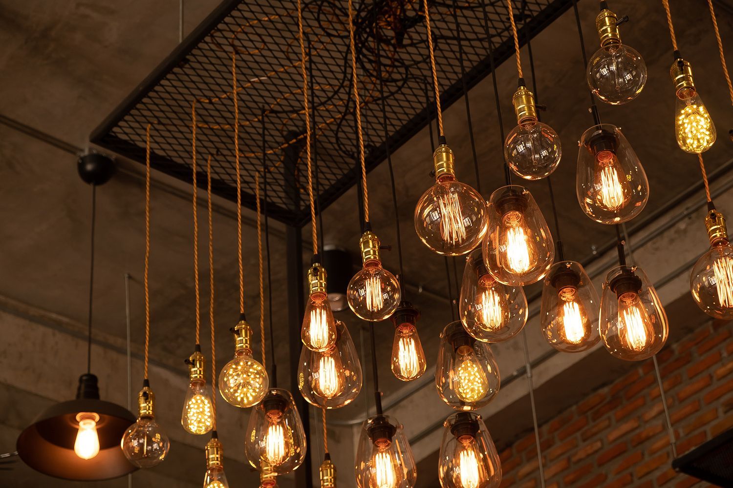 String lights with glowing Edison bulbs hang from the ceiling. String lights with glowing Edison bulbs hang from the ceiling.