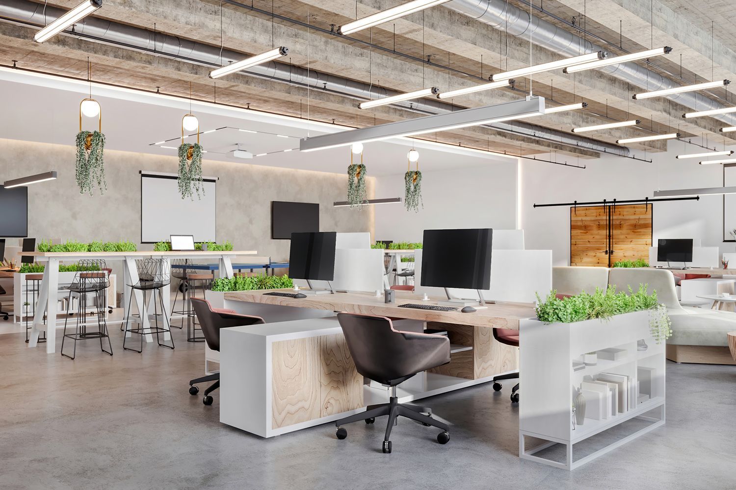 Modern office space with desks, plants, and exposed ceiling beams. Modern office space with desks, plants, and exposed ceiling beams.
