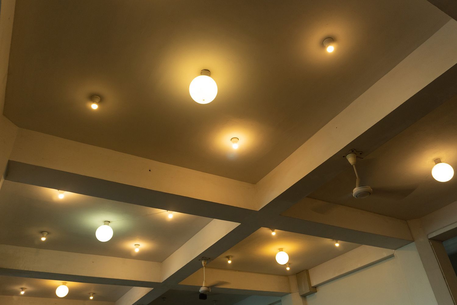Ceiling with multiple recessed lights and beams. Ceiling with multiple recessed lights and beams.
