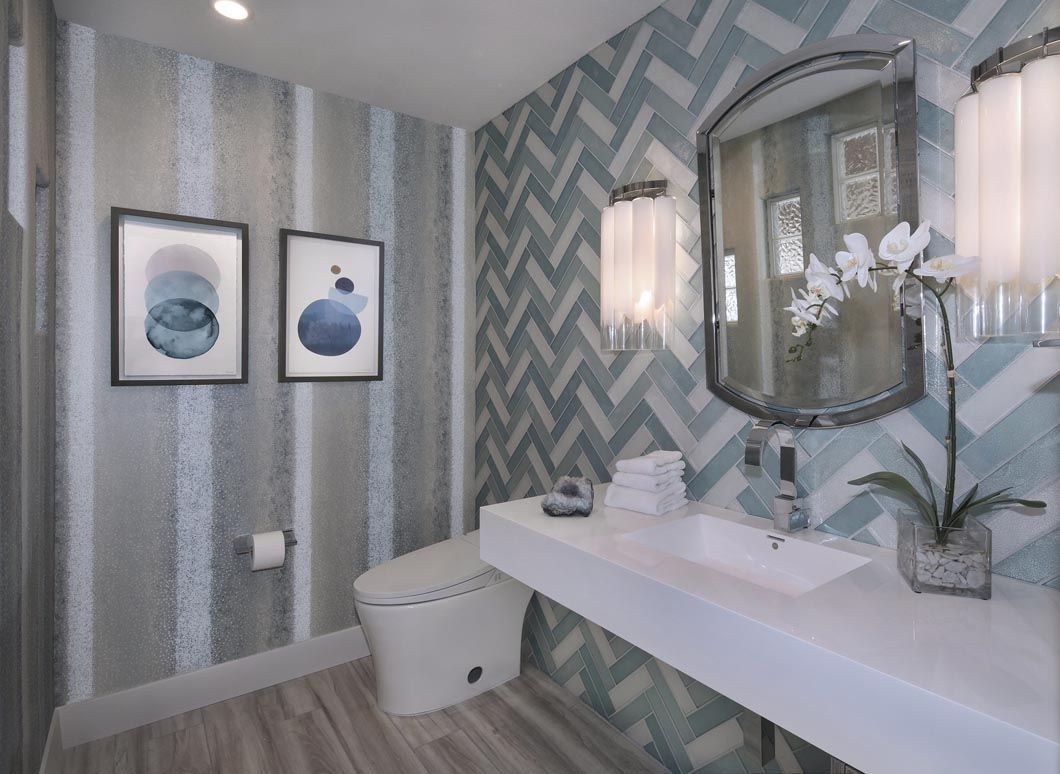 A bathroom with a toilet , sink and mirror.