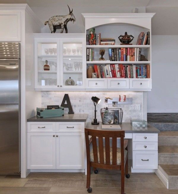 A kitchen with white cabinets and a letter a on the wall
