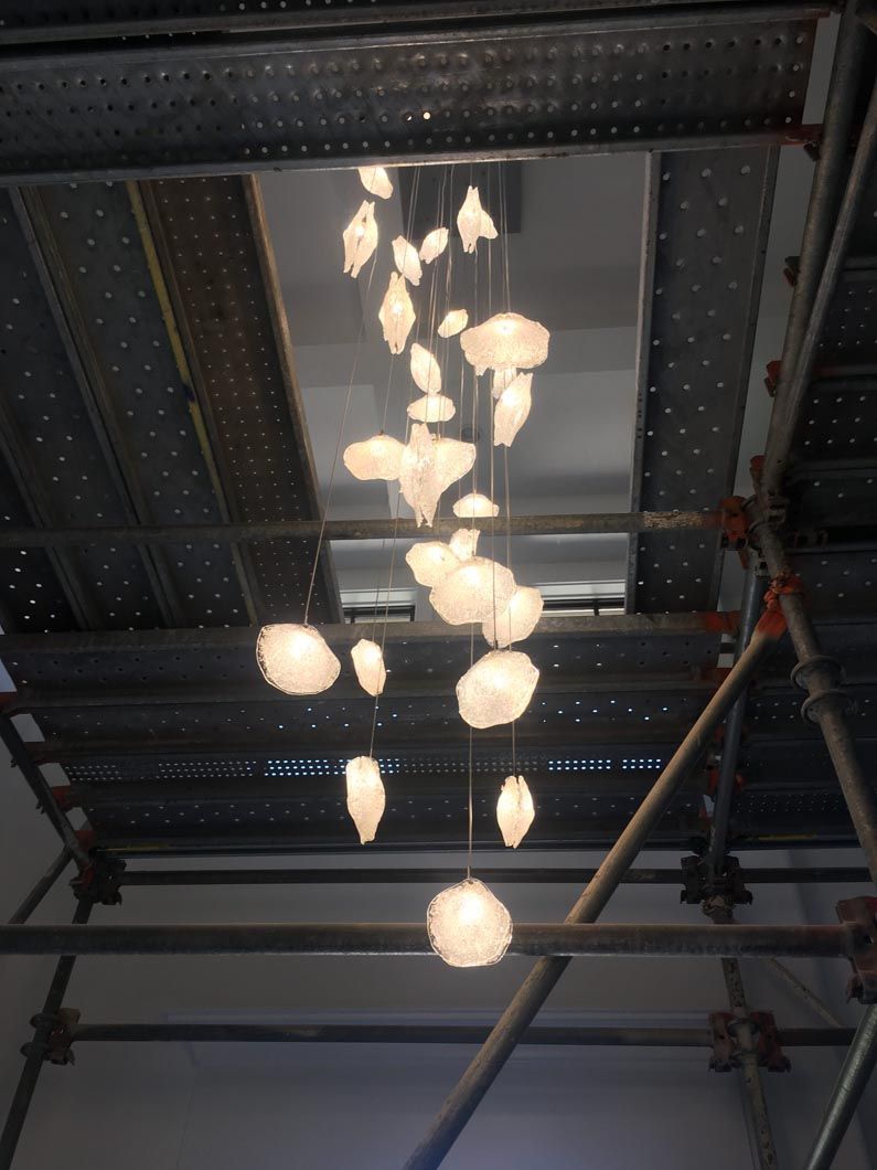 A ceiling with a bunch of lights hanging from it