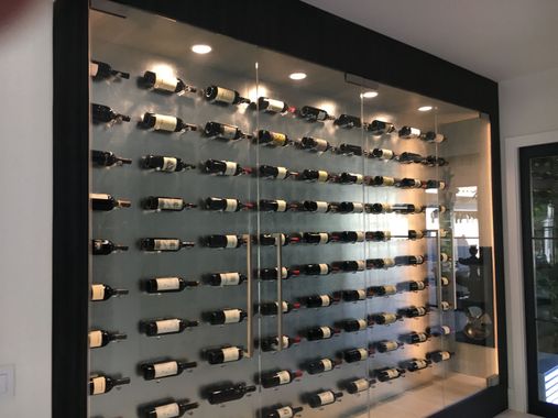 A wall filled with lots of bottles of wine