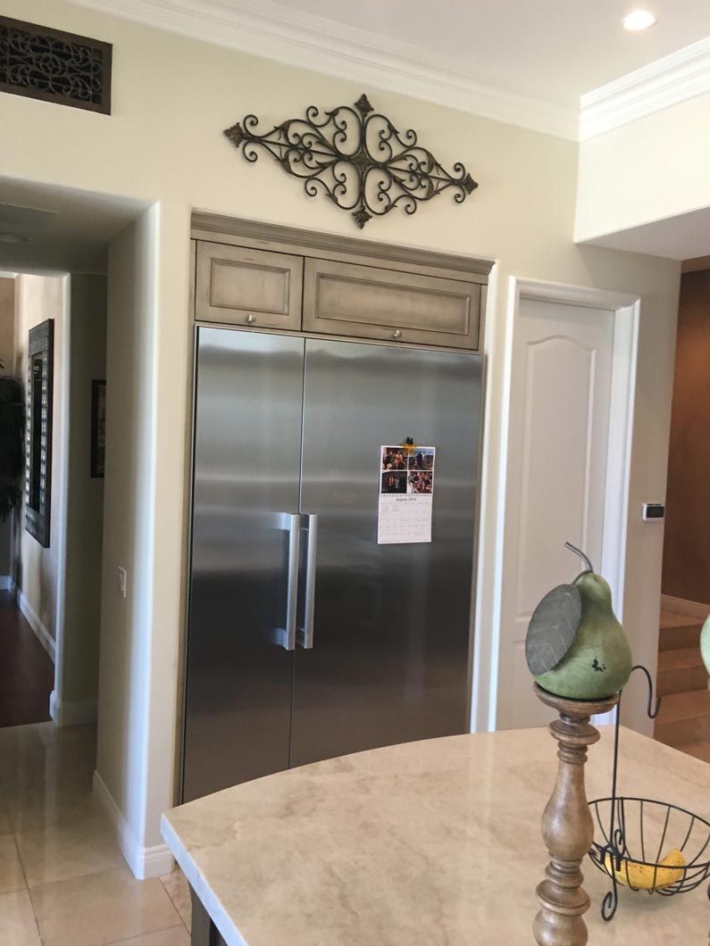 A kitchen with a large stainless steel refrigerator