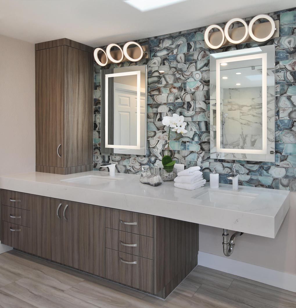 A bathroom with two sinks and two mirrors.