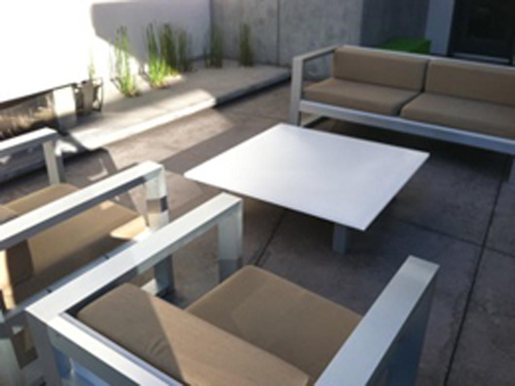 A patio with a couch and chairs and a table